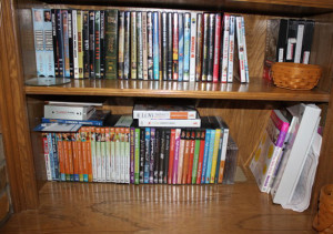 2 shelves of DVD's before being organized into binders
