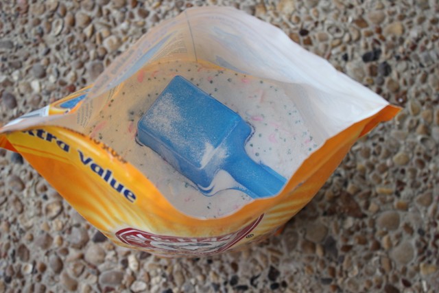 homemade laundry detergent stored in large baking soda bag after all mixed together in large bucket